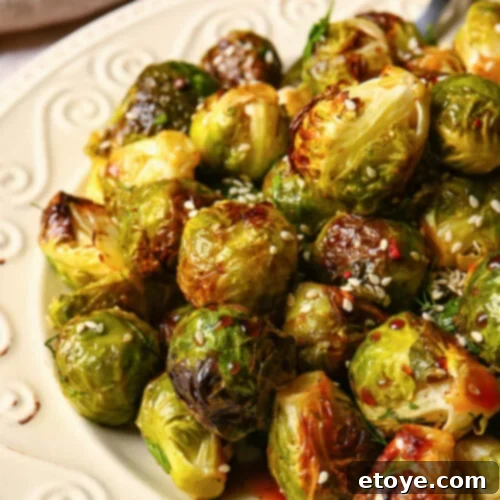 Crispy Sauteed Brussels Sprouts 5 A beautiful green bed of cooked brussel sprouts topped with sesame seeds.