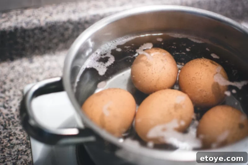 Perfectly Cooked Eggs: Soft and Hard Boiled Methods 2 hard boiled eggs in boiling water and pot