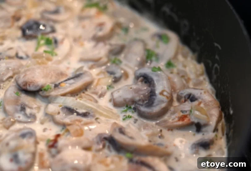 Velvet Boozy Mushroom Sauce 2 Sliced mushrooms in skillet with cream and herbs