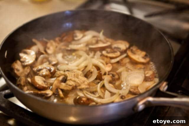 Velvet Boozy Mushroom Sauce 5 Serving creamy mushroom sauce with other components of a meal