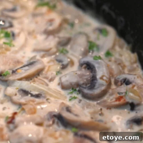Velvet Boozy Mushroom Sauce 6 Sliced mushrooms in skillet with cream and herbs