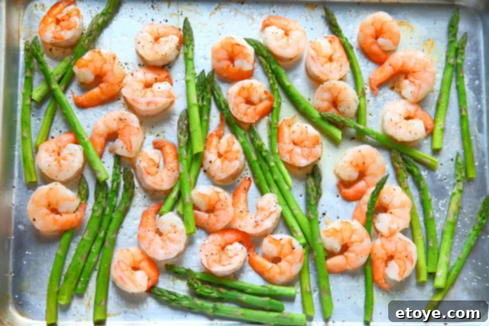 6 Creative Shrimp Recipes 4 Sheet pan with roasted shrimp seasoned with herbs and spices.
