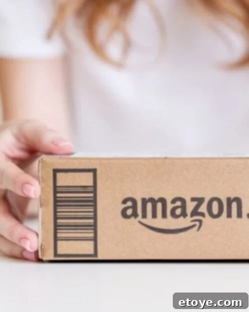 Stylized image of an Amazon gift card emerging from an Amazon box, representing the $100 Amazon Gift Card giveaway prize