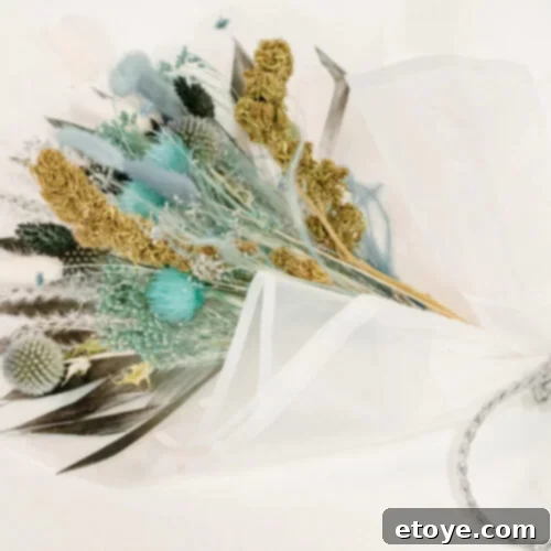 Think Inside The Box Your Essential Subscription Gift Guide 7 A delicate and aesthetic bouquet of dried CBD hemp flowers and soft feathers in muted, natural tones, beautifully arranged against white paper and tied with a ribbon, showcasing LovePot's unique offering for natural relaxation and home decor.