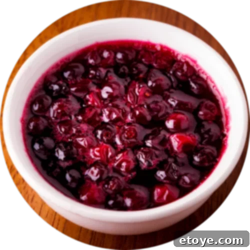 A white bowl of cranberry sauce