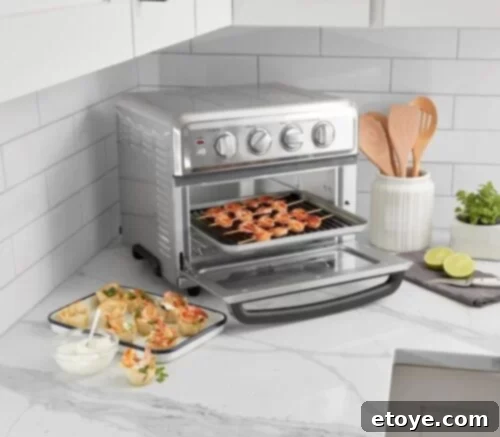Close-up of food being cooked inside the Cuisinart Air Fryer + Convection Toaster Oven, demonstrating its cooking capabilities