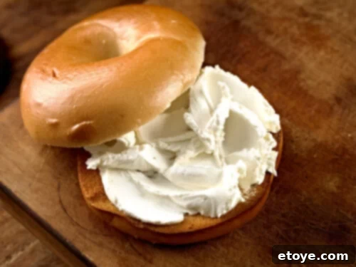 Cream cheese spread onto a bagel