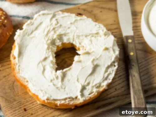 Half a bagel with cream cheese on top