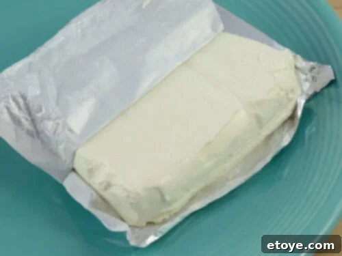 An opened package of cream cheese