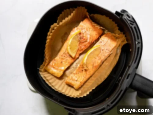 Salmon with lemon on parchment liner in air fryer