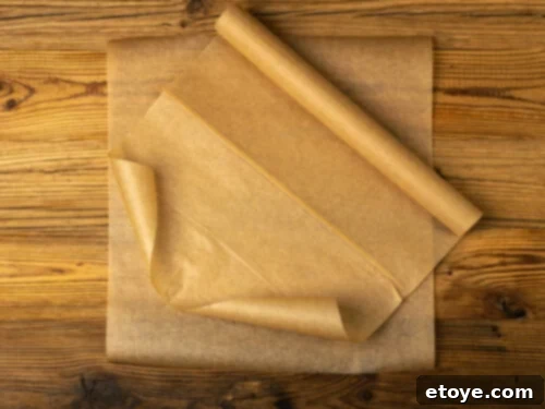 Close-up view of various rolls of parchment paper, including bleached and unbleached options, ready for kitchen use.