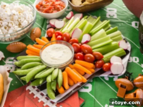 Super Bowl party table laden with various snacks and drinks, ready for the big game.