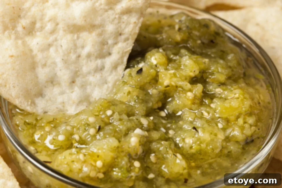 Close-up of fresh tomatillos, the key ingredient for salsa verde, on a wooden board