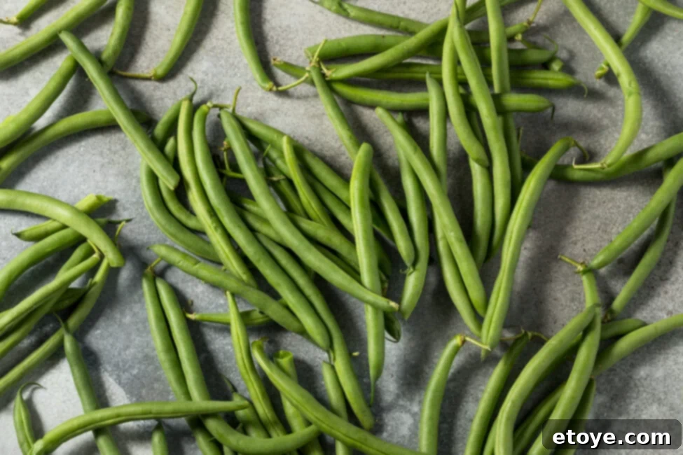 Hand holding fresh green beans
