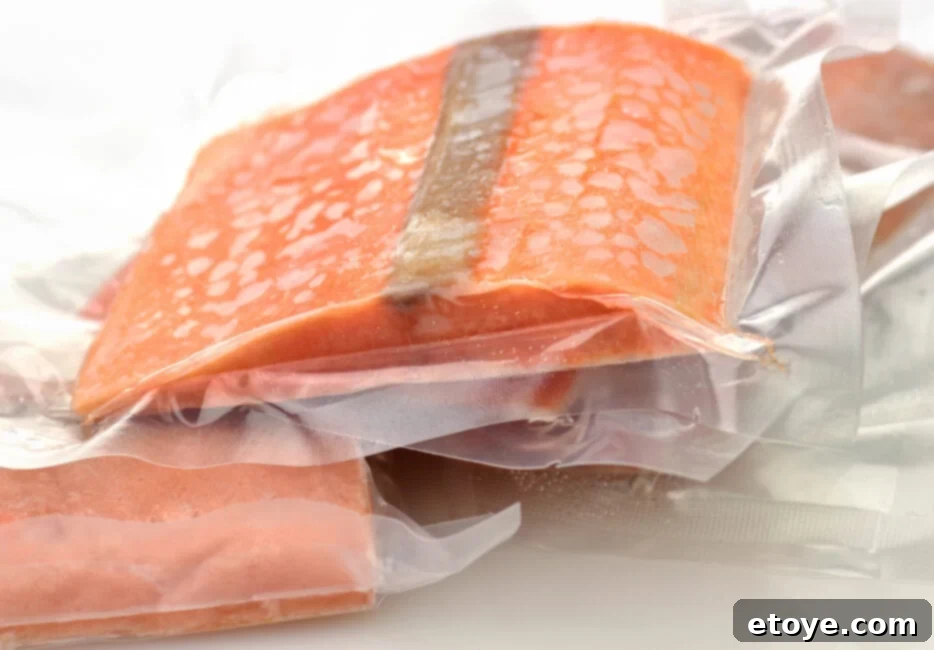 Salmon Fridge Life Explained 4 Someone checking a salmon fillet for freshness by touching it, indicating the importance of the touch test.