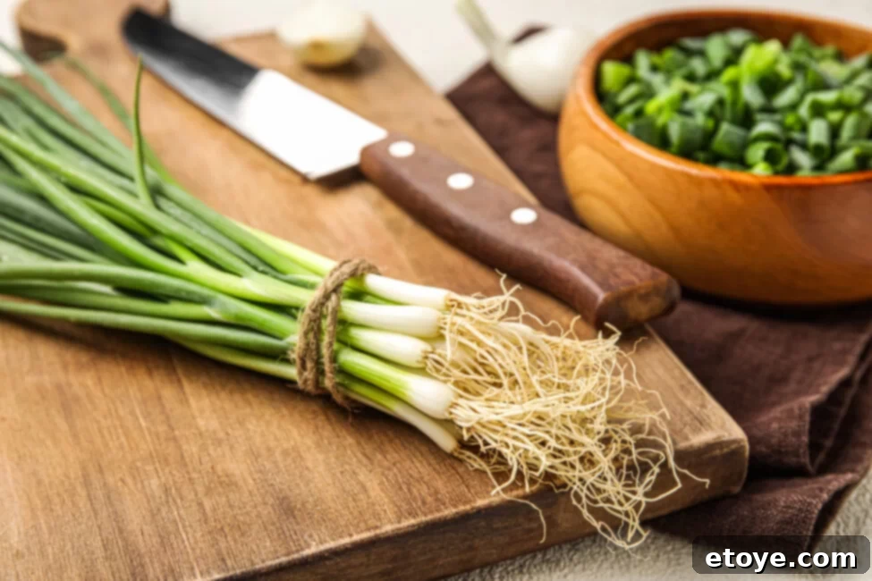 Maximize Green Onion Freshness in the Fridge 2 Freshly harvested green onions with white bulbs and vibrant green stalks, ready for storage.