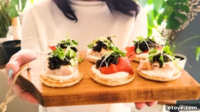 Great Taste's Kaluga Sturgeon: Our Review and Storage Secrets 4 Jaden holding a blini spread on a cutting board