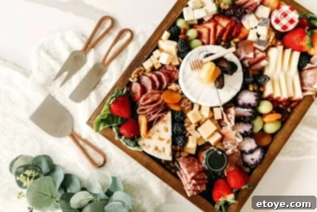 Top 5 Online Cooking Programs to Master Your Kitchen Skills 5 An elegantly arranged charcuterie board featuring cheeses, meats, fruits, and crackers, ideal for an online charcuterie class.