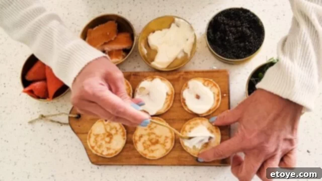 The Ultimate Salmon Blini Board 5 Spoon on some creme fraiche