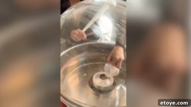Pouring more sugar into the cotton candy machine