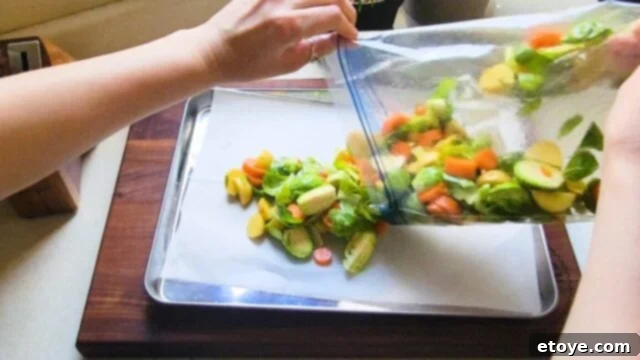 Pouring veggies onto a sheet pan