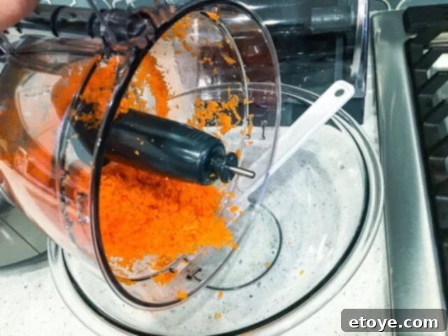 Getting Started With Your Food Processor 3 Various food processor attachments and bowls displayed on a kitchen counter.