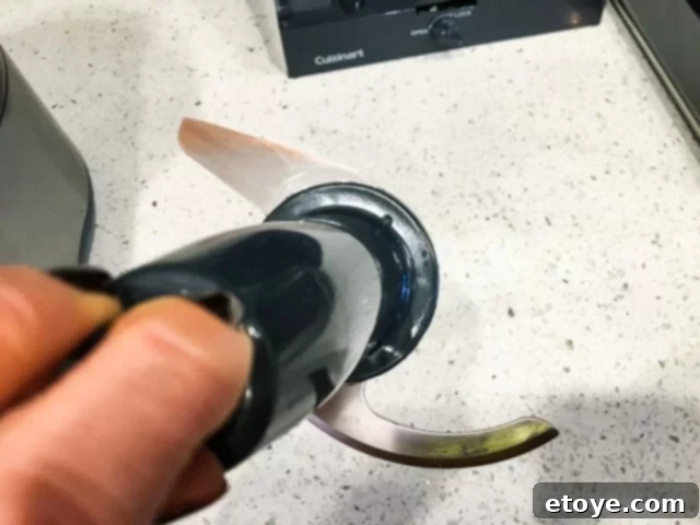 Getting Started With Your Food Processor 5 A kitchen counter with various freshly prepared ingredients and a food processor in the background.