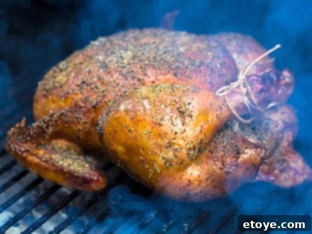 Smoking a whole chicken, a quintessential summer cooking activity for flavorful smoked meats.