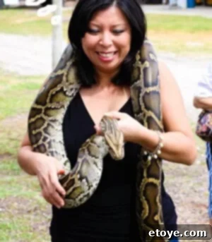 Jaden holding a Burmese Python, a symbolic act of facing her fears directly