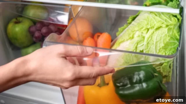 Summer Vegetable Harvest Your Ultimate Guide 11 A crisper drawer in a refrigerator filled with a variety of fresh fruits and vegetables, highlighting proper storage for produce longevity.