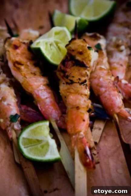 Exquisite Lemongrass Ginger Grilled Shrimp Dish Perfectly grilled lemongrass ginger shrimp skewers served with lime
