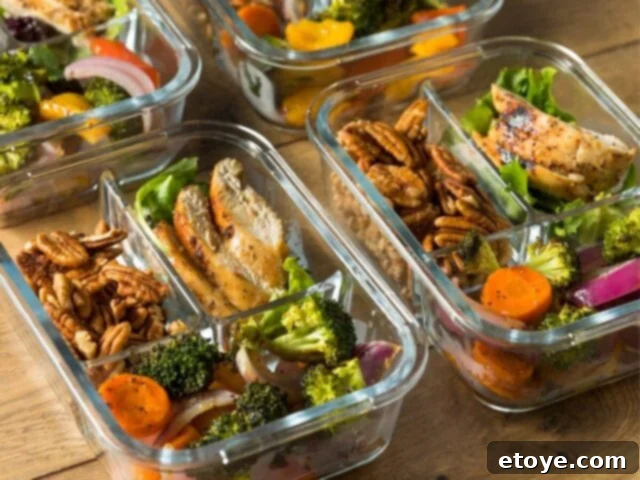 Colorful meal prep bowls with chicken, rice, and vegetables