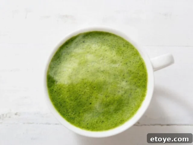 Starbucks Green Tea Matcha Latte Ingredients 4 A serene shot of a matcha latte, garnished with a delicate leaf design, suggesting calm and natural goodness.