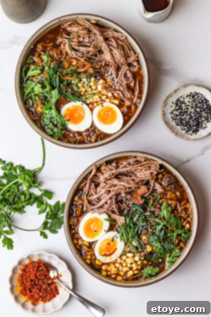 Steaming bowl of homemade Beef Ramen Noodle Bowl with tender beef and toppings