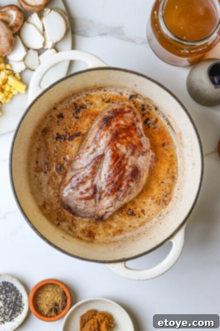 Browning beef chuck roast in a Dutch oven for ramen