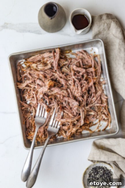 Shredding tender beef after slow-braising