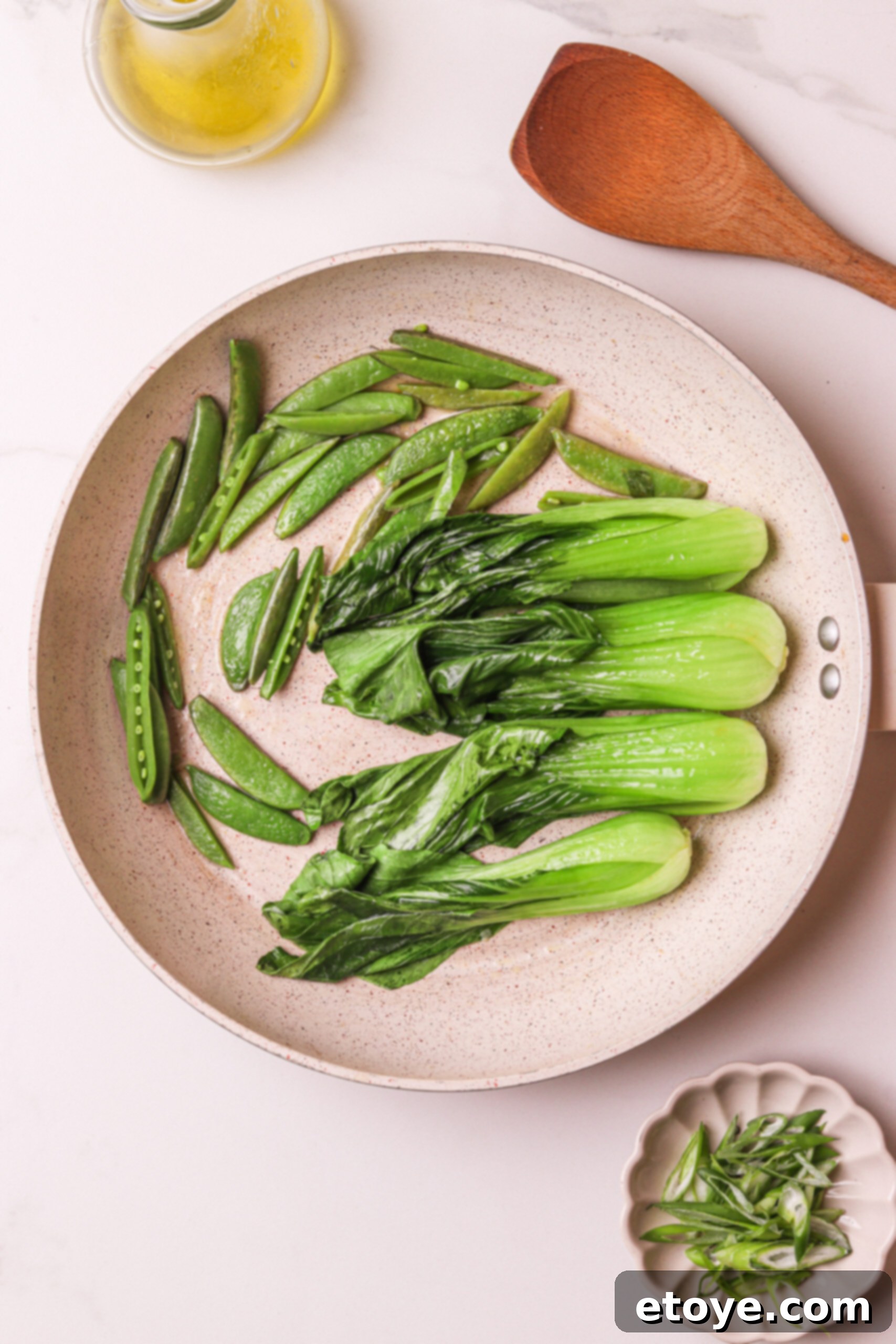 Spicy Honey Glazed Crispy Salmon Bowl 9 Sautéing pak choi and snap peas