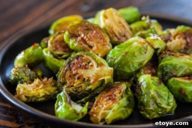 The Ultimate Guide to Fall Vegetables 3 Crispy roasted Brussels sprouts, perfectly caramelized, served in a rustic bowl.