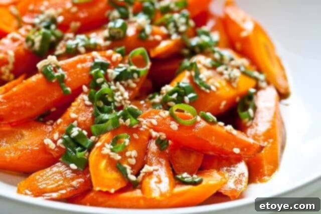 The Ultimate Guide to Fall Vegetables 7 Roasted carrots with a glossy glaze, garnished with fresh herbs, showcasing a delicious side dish.