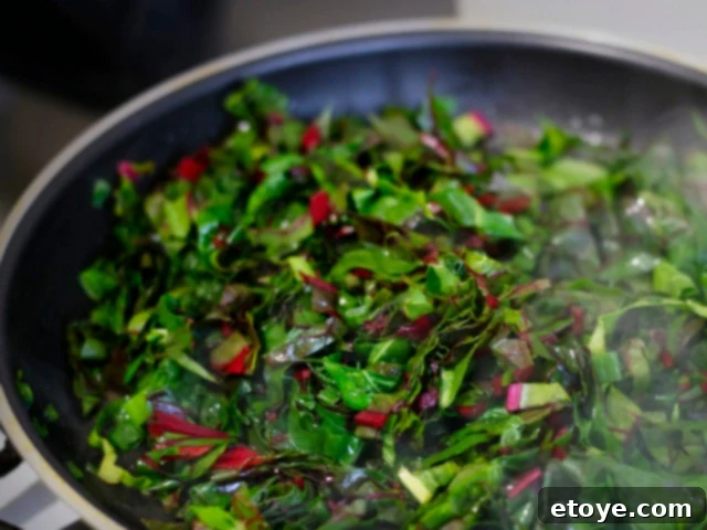 The Ultimate Guide to Fall Vegetables 9 Colorful Swiss chard leaves with bright red, yellow, and orange stems.
