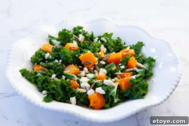The Ultimate Guide to Fall Vegetables 10 A vibrant salad featuring roasted squash, kale, and feta cheese with a walnut vinaigrette, illustrating a healthy and flavorful meal.