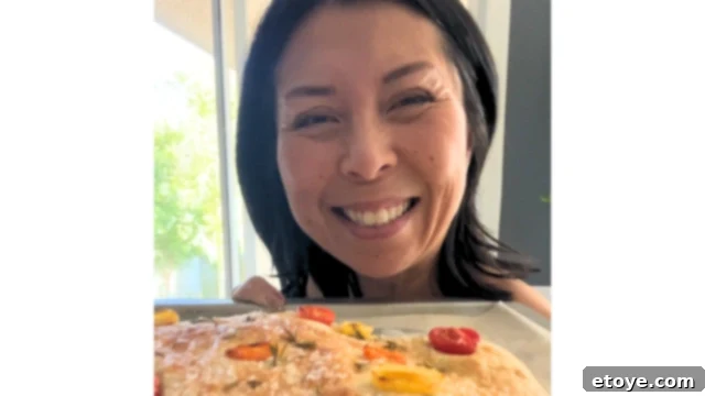 Bosch Universal Plus Kitchen Mixer Deep Dive 12 Jaden smiling and proudly holding a slice of her homemade pizza, fresh from the oven.