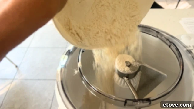 Bosch Universal Plus Kitchen Mixer Deep Dive 5 Bosch Universal Plus Kitchen Stand Mixer with flour in its mixing bowl, ready for baking preparation.