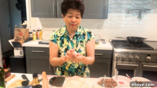 Bosch Universal Plus Kitchen Mixer Deep Dive 6 Mom with the bread dough, skillfully shaping it into pizza crust for a family gathering.