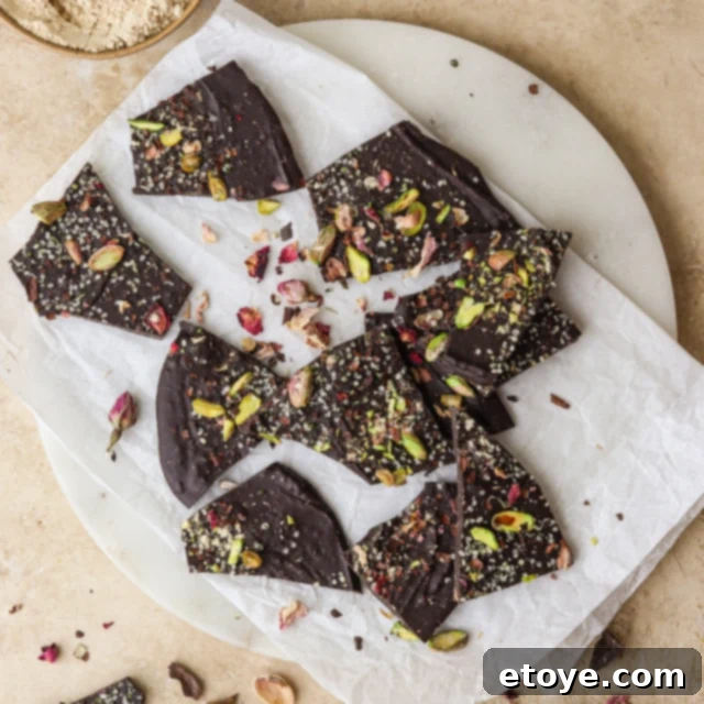 Decadent Rose Maca Chocolate Bark 2 Rose and Maca Chocolate Bark served on a white plate, showcasing its rich texture and decorative toppings.