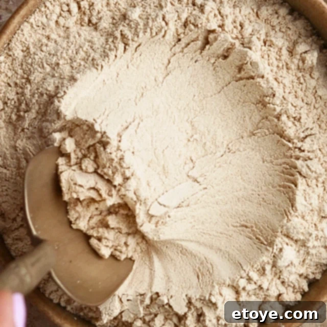 Decadent Rose Maca Chocolate Bark 3 A scoop of organic maca powder in a small bowl, ready for use in the recipe.