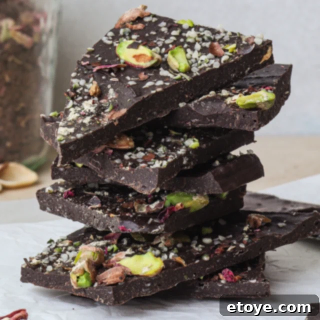 Decadent Rose Maca Chocolate Bark 5 Stacked pieces of Rose and Maca Chocolate Bark, showing their layers and toppings.