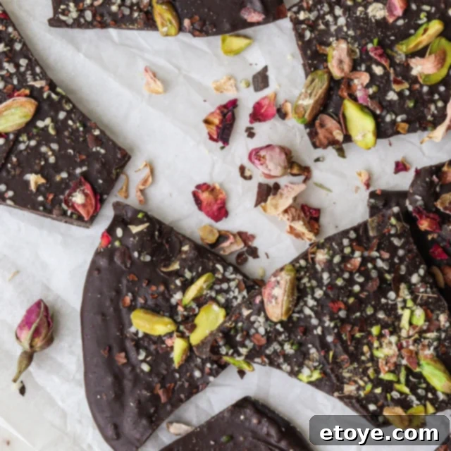 Decadent Rose Maca Chocolate Bark 8 Close-up of Rose and Maca Chocolate Bark on a wooden surface.
