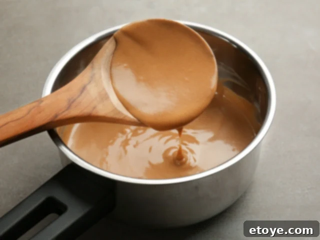 Reheating gravy in a small saucepan on a stovetop