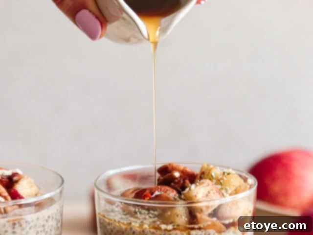 Close up of honey being drizzled over Winter Chia Pudding with apple topping